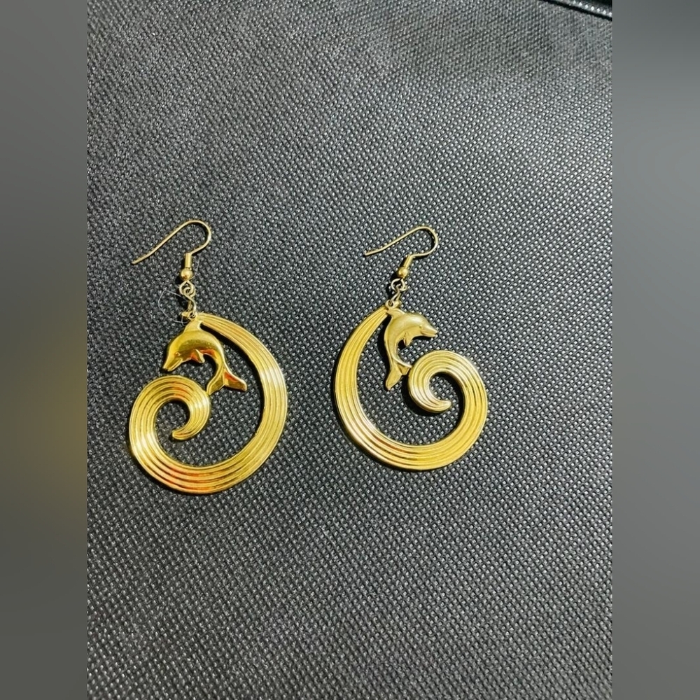 Beautiful gold earrings with dolphins